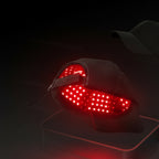 Light therapy hair health cap with red LED lights on a clear stand against a light blue background.
