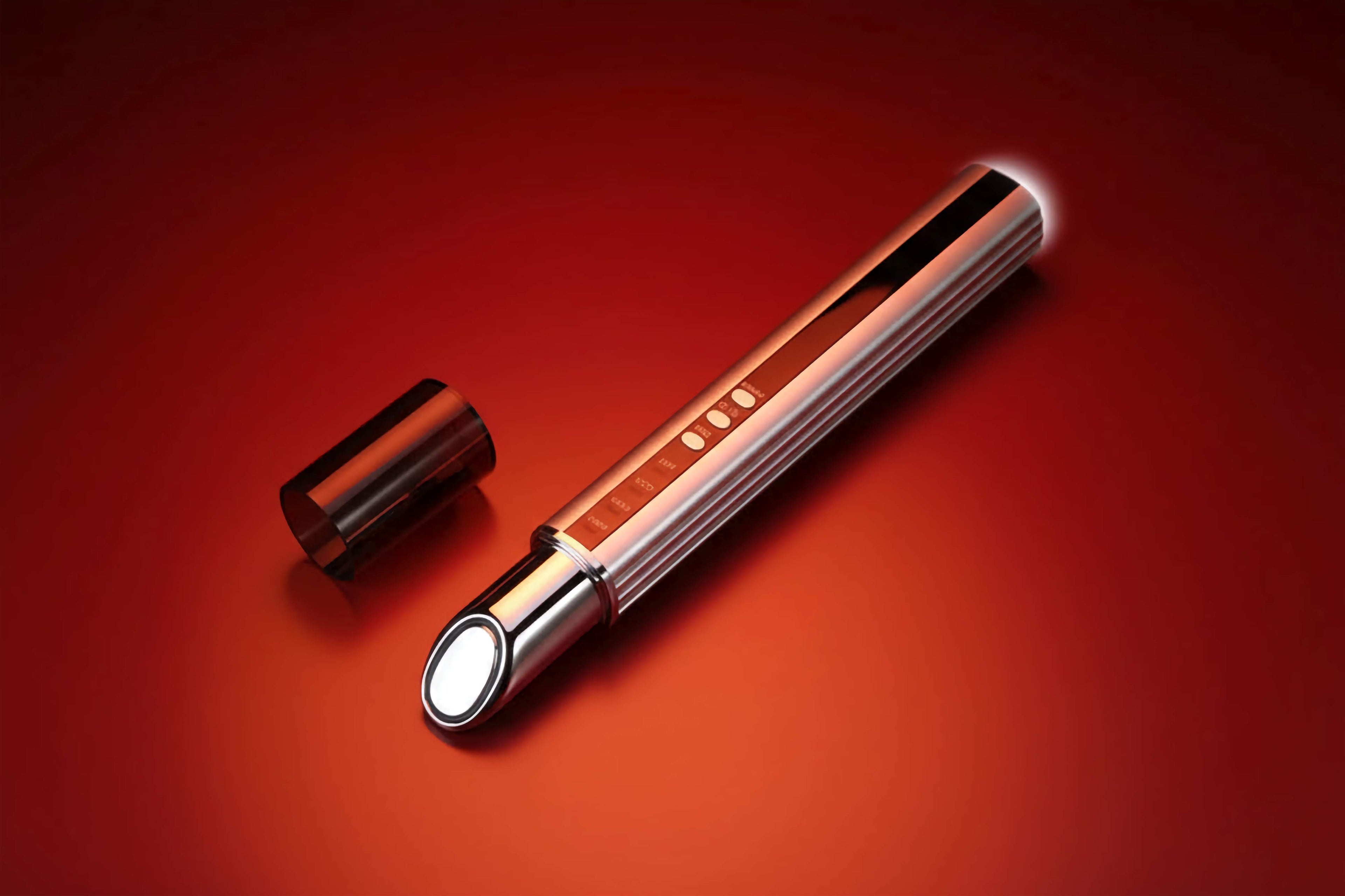 Cylindrical metallic object with a reflective surface on a red background